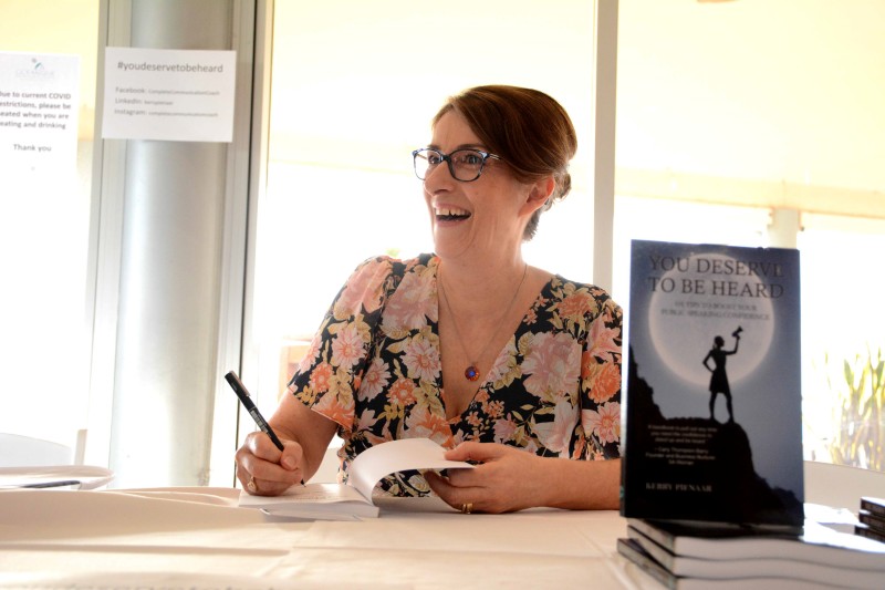 Laughing while signing book